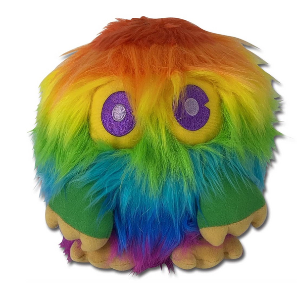 A fuzzy monster plush toy with rainbow-colored hair in orange, yellow, green, blue, and purple, featuring large purple eyes with silver glittery centers and a wide open mouth showing beige teeth, set against a plain white background.
