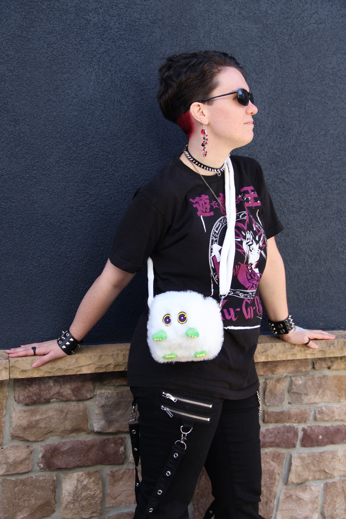 Kuriboo plush deck box worn on a shoulder strap